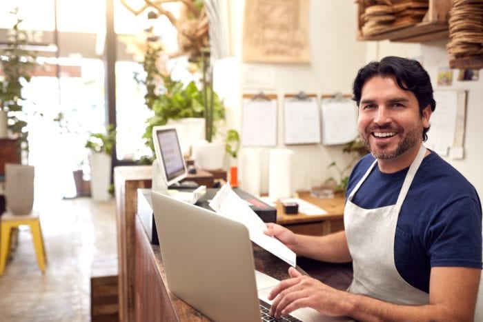 business owner using his laptop inside his bakery